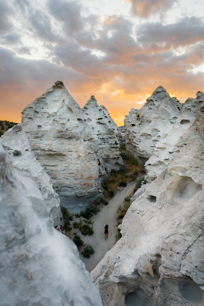 Teepee Rocks with girl hiking down. Photo by Sarah Rohrbach
