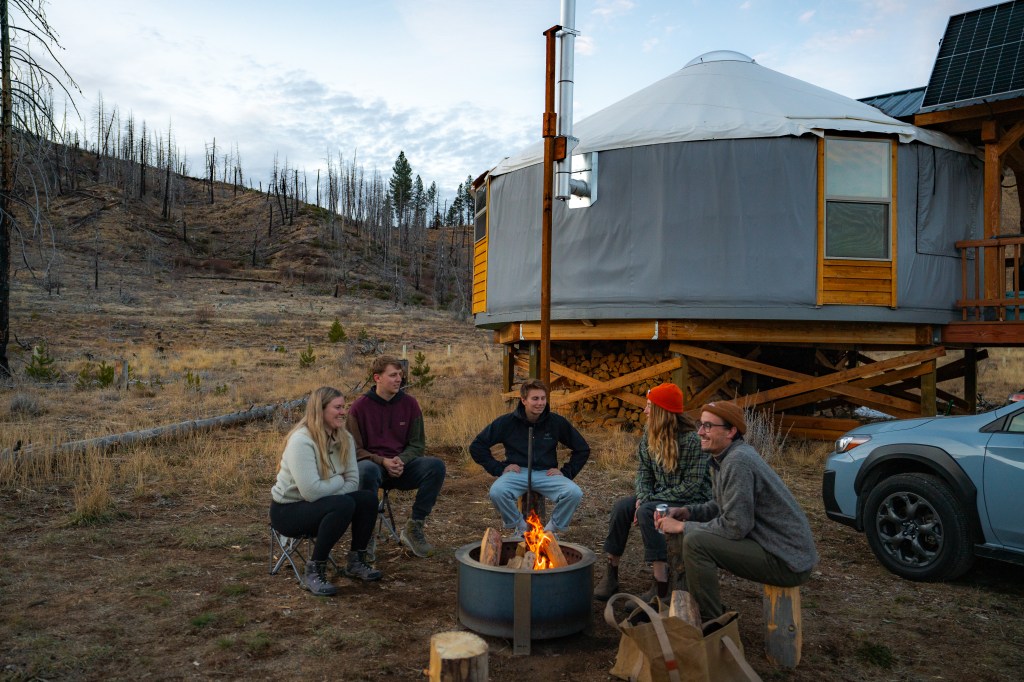 Friends hanging around the fire outside of the Green Yurt at Idaho Wilderness Yurts